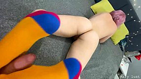 18-year-old girl with pink hair gives a reverse footjob to an older man in cosplay