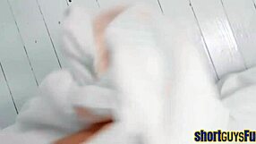 The heavy breasted young lady then kisses then climbs on top of a shorter man before the two of them spoon