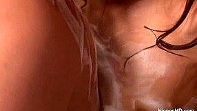 Beautiful Japanese woman gives a very sensual massage with oil and then has sex