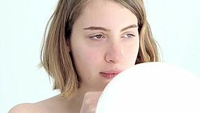 Young and straight forward looner girl giving blow job to a balloon